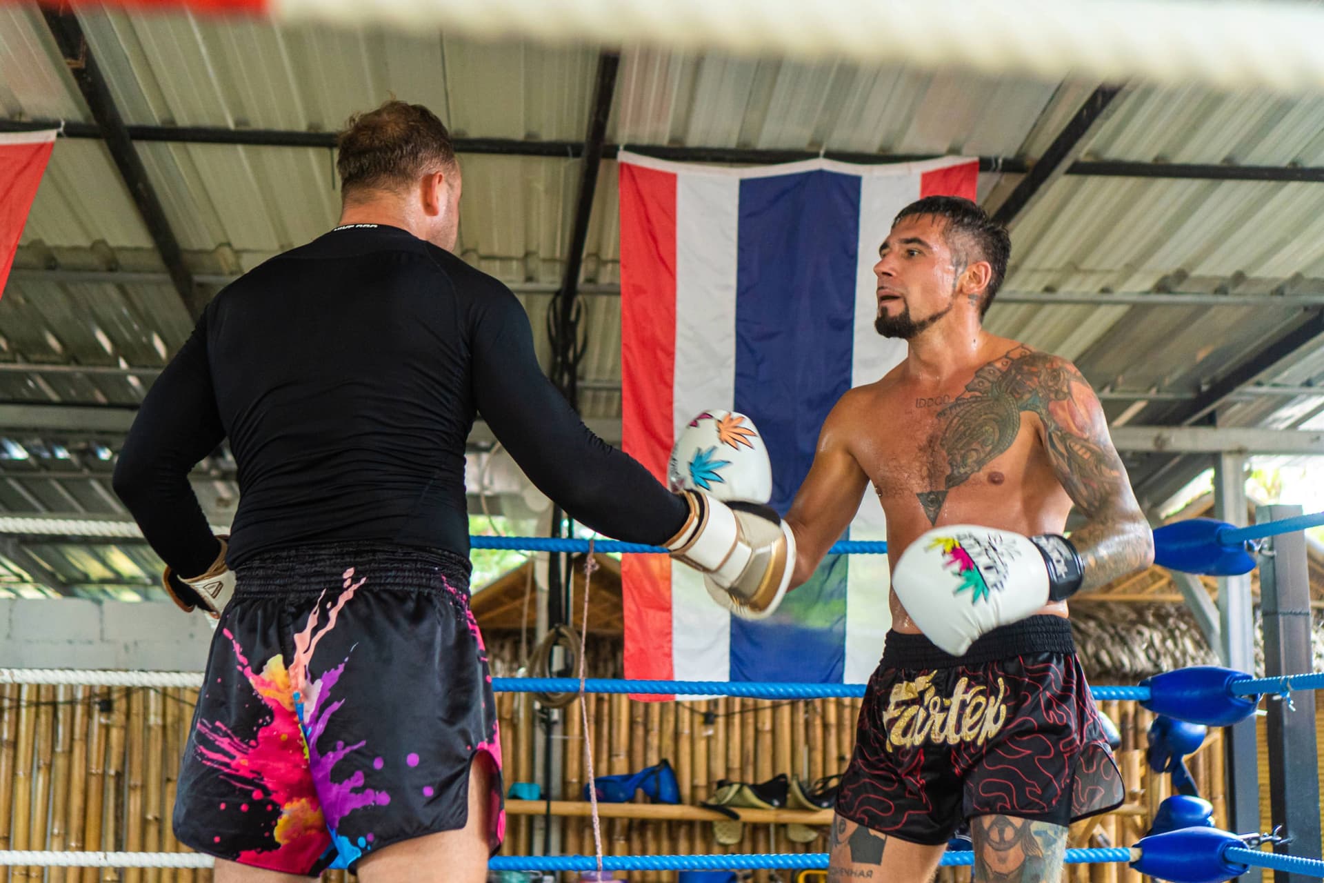 2 Muay Thai Fighters in Sor Saktai showing respect to each other after round