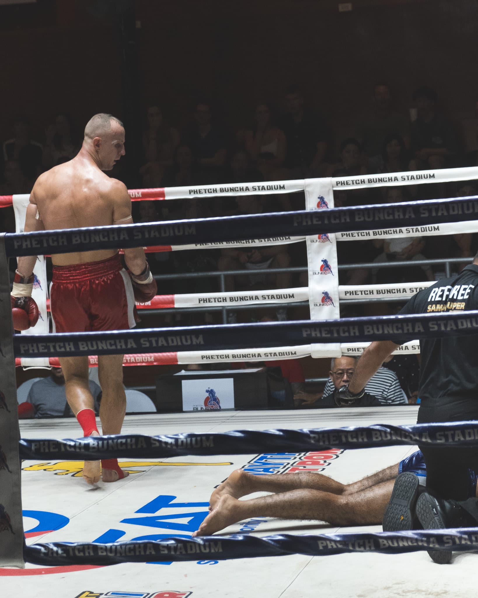Russian fighter walking after knocking out his opponent in Phetchbuncha stadium on Koh Samui