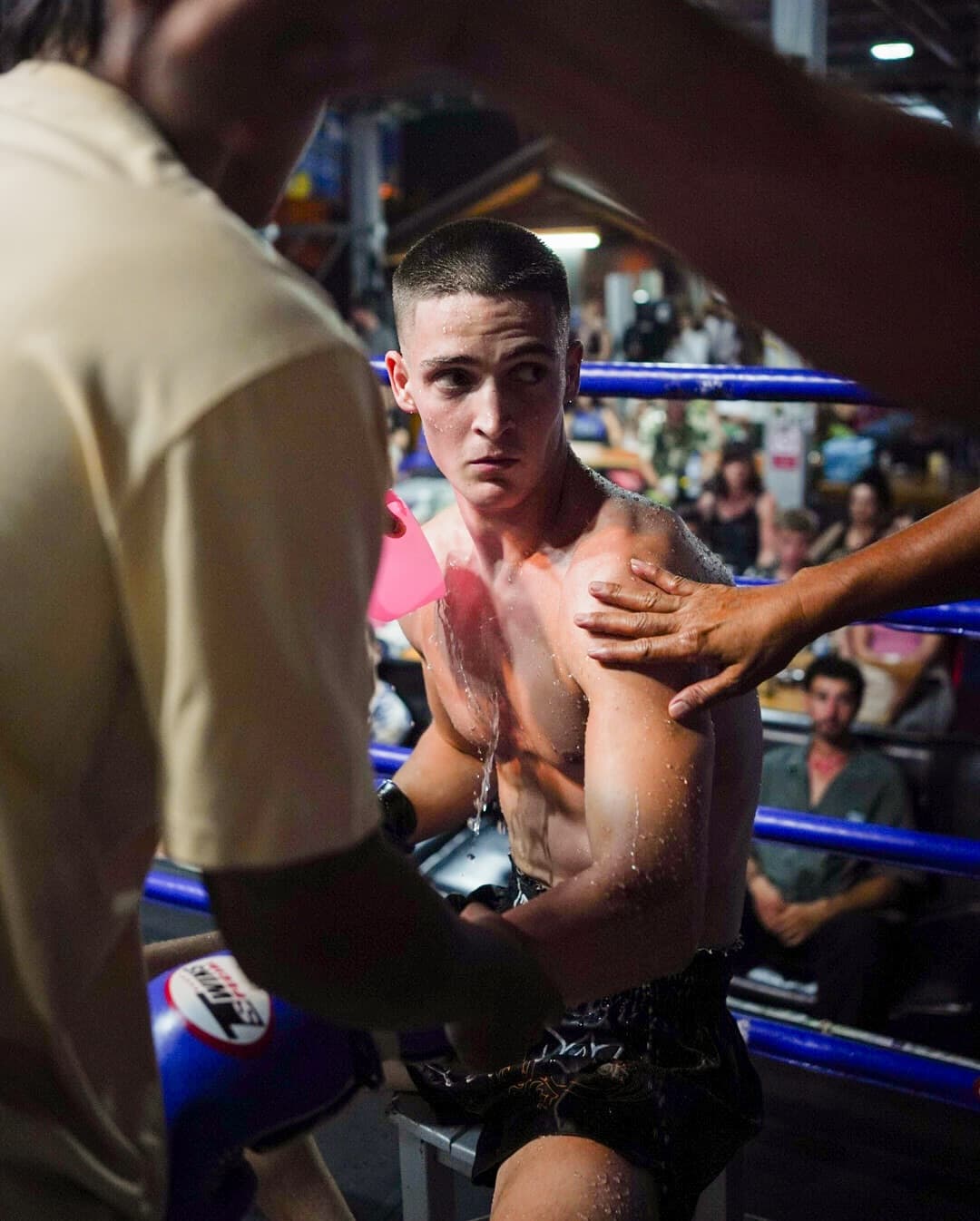 Foreign fighter listening to corner advise during his first fight on one of Koh Phangan stadiums
